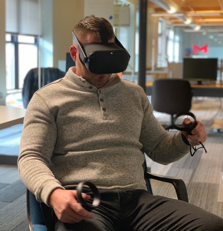 A person using a virtual reality headset and hand controllers